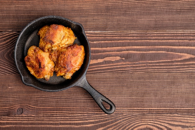 Fried chicken thighs in cast iron skillet