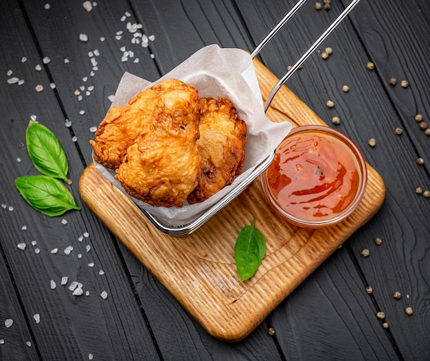 Fried chicken wings in batter with hot sauce