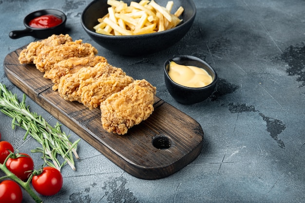 Fried chicken wings parts on grey background