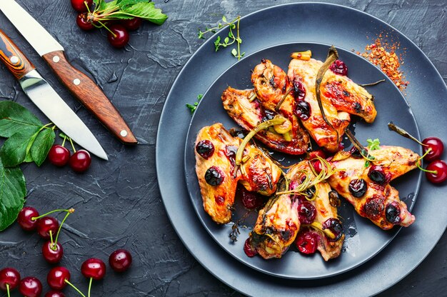 Fried chicken wings in spicy cherry sauce.Grilled chicken, fast food.