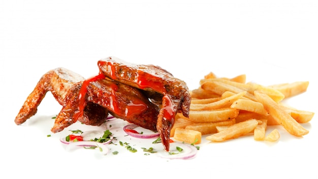 Fried chicken wings with French fries on white isolated background