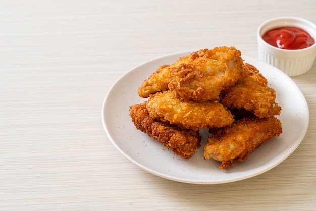 Fried chicken wings with ketchup - unhealthy food