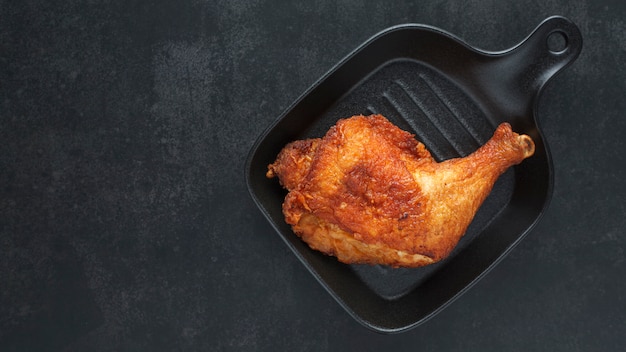 Fried chicken with black pan