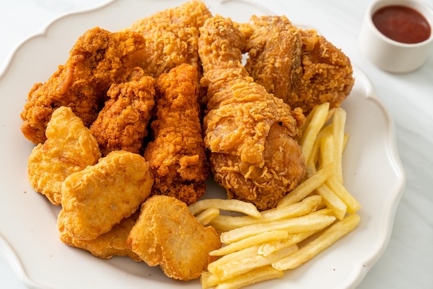 Fried chicken with french fries and nuggets on plate