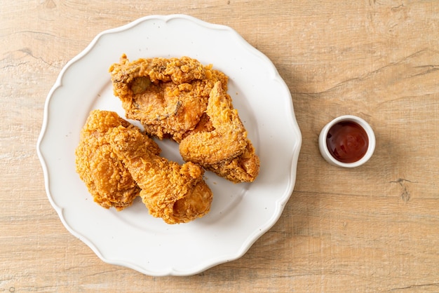 Fried chicken with ketchup on plate - unhealthy food