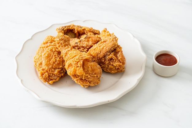 プレートにケチャップを入れたフライドチキン