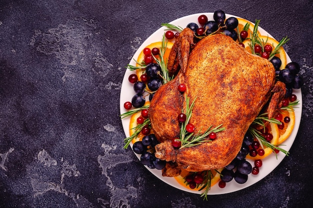 Fried chicken with rosemary and garnish served on a white plate