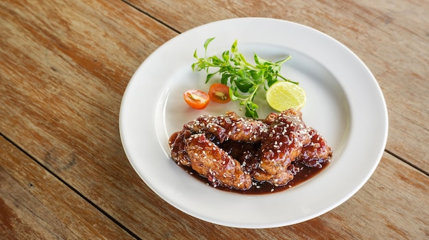 Fried chicken with sweet sauce on a white plate.