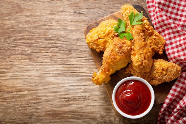 Fried chicken on a wooden board