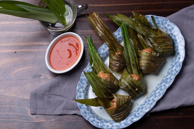 Foto pollo fritto avvolto in foglia di pandan