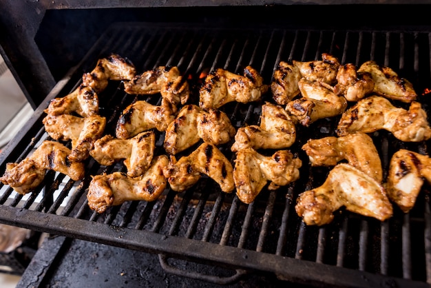 Fried chiken wings at grill barbecue. Restaurant.