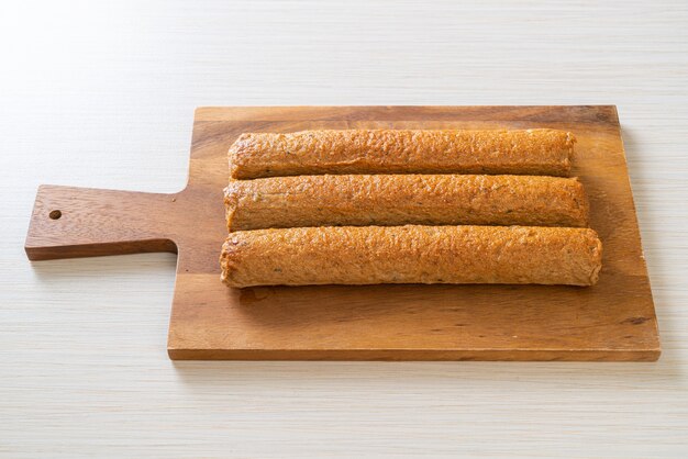 fried Chinese fish cake or fish ball line on wood board