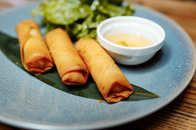 Fried chinese spring rolls with sweet chili sauce.