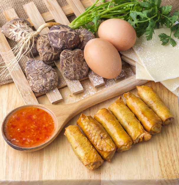 Fried chinese spring rolls with sweet chili sauce.