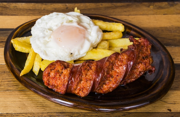 Photo fried chorizo with egg and fries