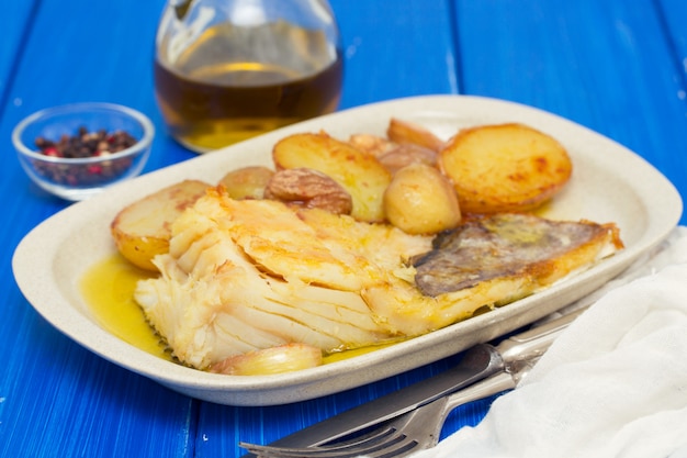 Fried cod fish with chestnuts and potato  on white dish