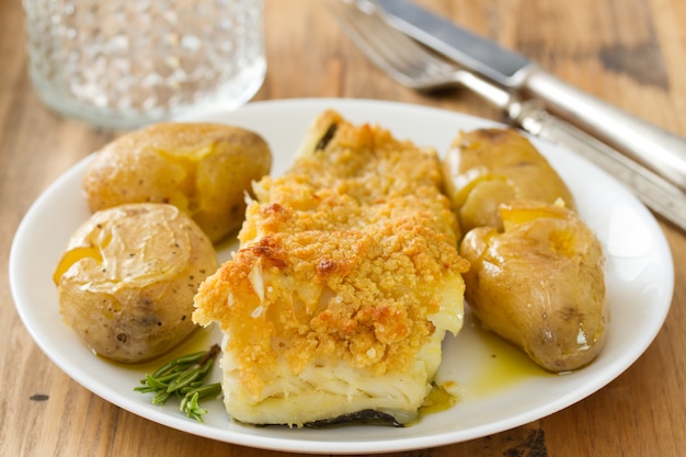 Fried codfish with broa and potato on dish