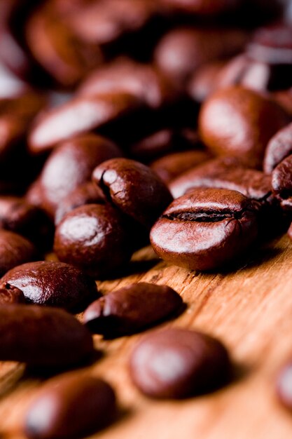 Fried coffee beans closeup on wooden background