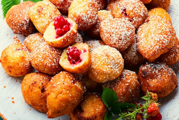 Fried cottage cheese donuts with berries.Donuts on a plate