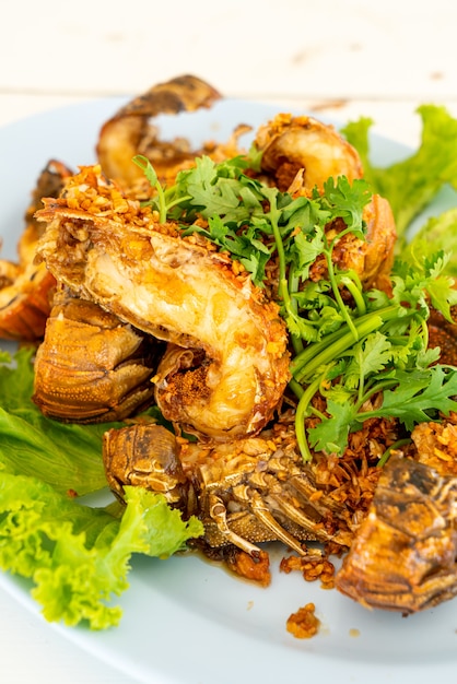 Fried crayfish or mantis shrimps with garlic. seafood style