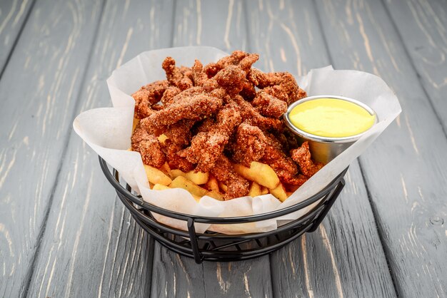 Fried crispy chicken nuggets with french friesnd ketchup