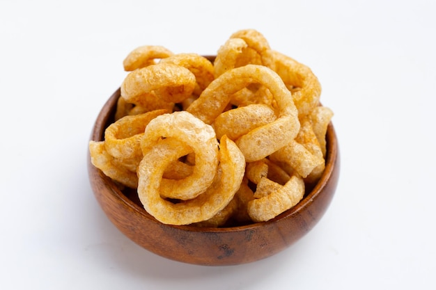 Fried crispy pork rinds on white background