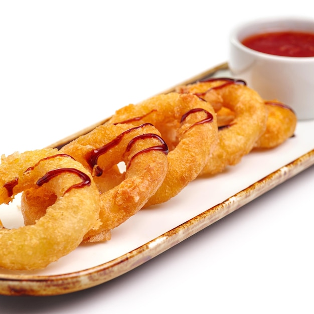 Fried crispy squid rings breaded caramari with red sauce on white backgruond For the restaurant menu Traditional Japanese sushi seasoning Healthy eating