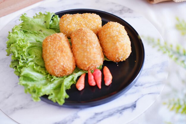 Fried croquettes on a black plate Selective focus