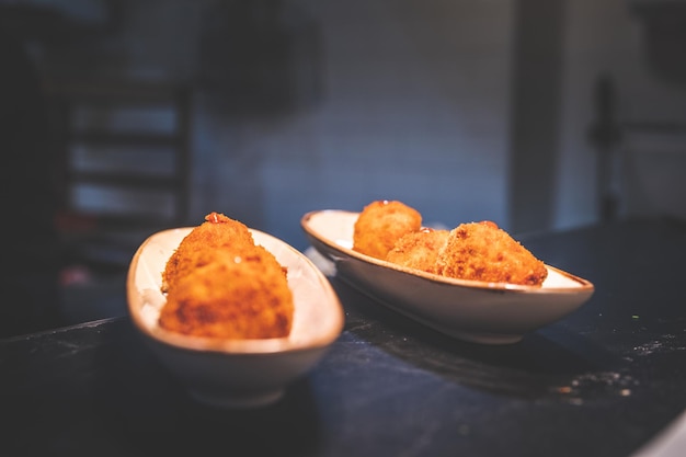 Photo fried croquettes on two plates at a restaurant cuisine.