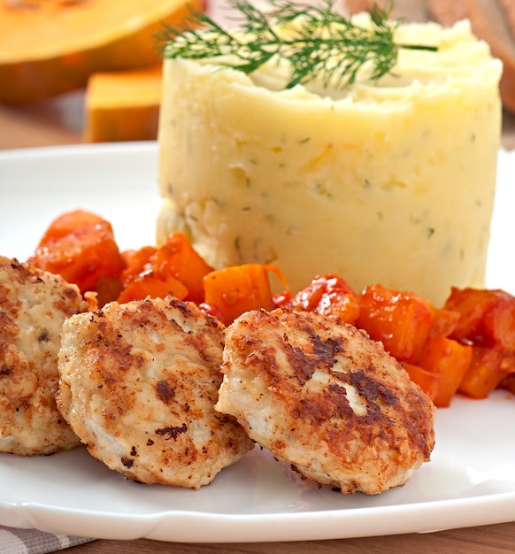 Fried cutlets, stewed pumpkin and mashed potatoes