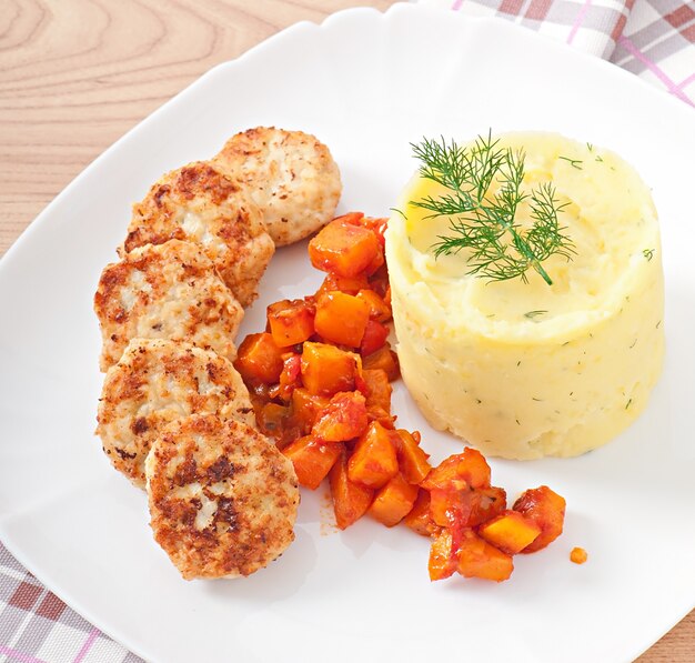 Fried cutlets, stewed pumpkin and mashed potatoes