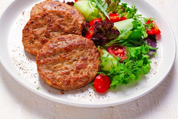 Fried cutlets turkey with vegetable salad top view no people