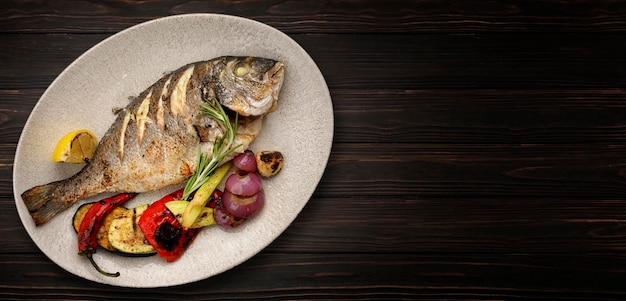 Fried dorado fish with grilled vegetables and lemon