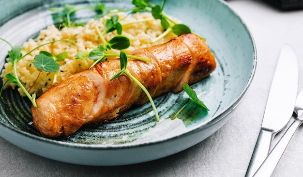 Fried duck fillet with rice on a plate