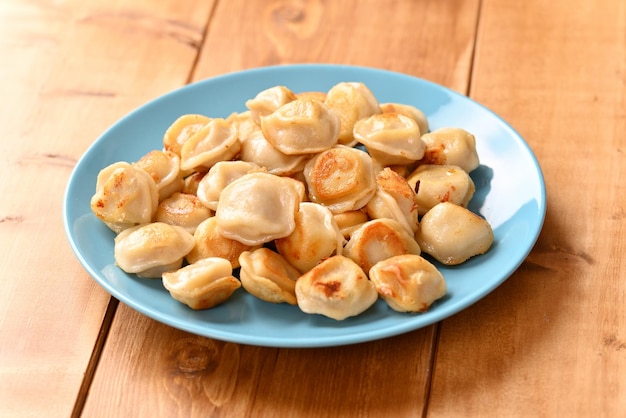 Fried dumplings on a blue plate.