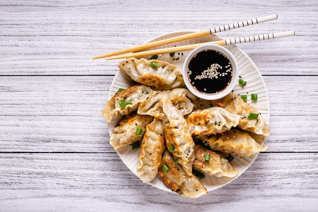 Fried dumplings gyoza with soy sauce and chopsticks