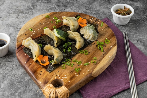 Fried dumplings gyoza with soy sauce served in a wood