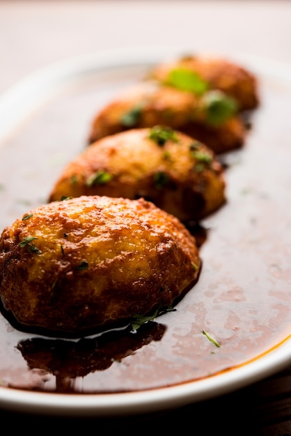 Fried egg curry or anda masala served in a bowl