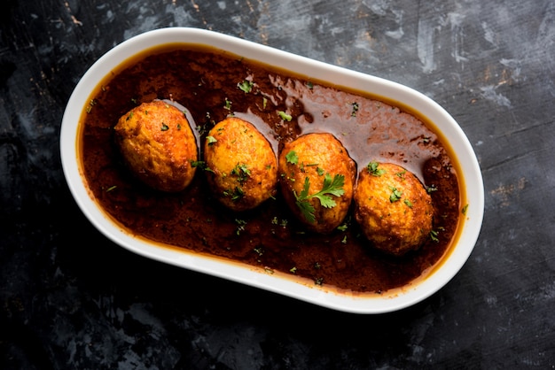 Fried egg curry or anda masala served in a bowl