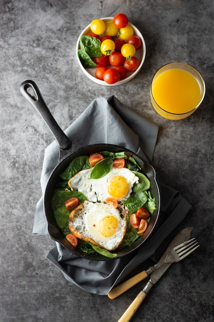 Fried egg on a pan served with fresh cherry tomatoes, Healthy breakfast,