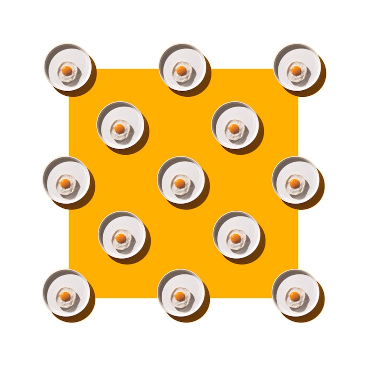 Photo fried egg on a round plate on a yellow table with hard shadows creative pattern
