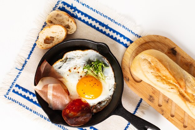 fried egg in skillet iron pan with flax sprouts and bacon with copy space 