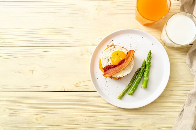 fried egg with bacon and cheese on pancake