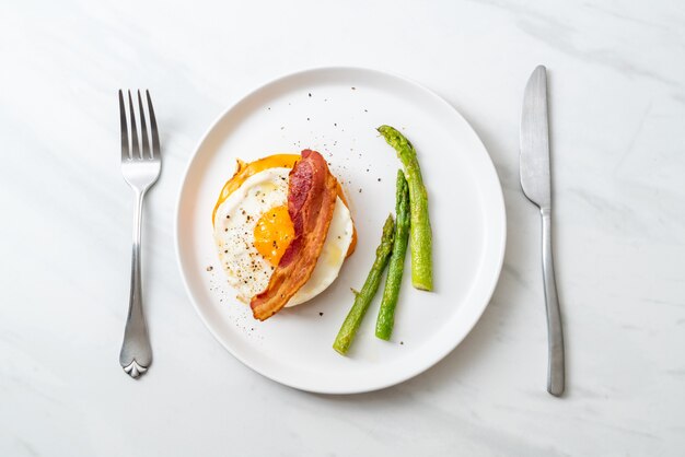 fried egg with bacon and cheese on pancake