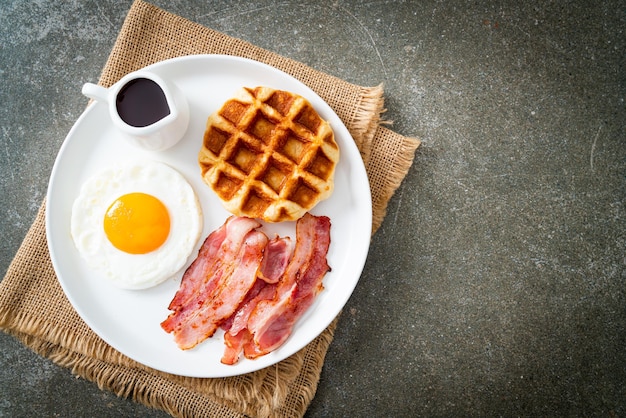 fried egg with bacon and waffle for breakfast