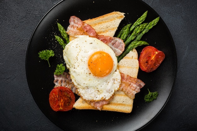 Fried egg with bread toast and asparagus