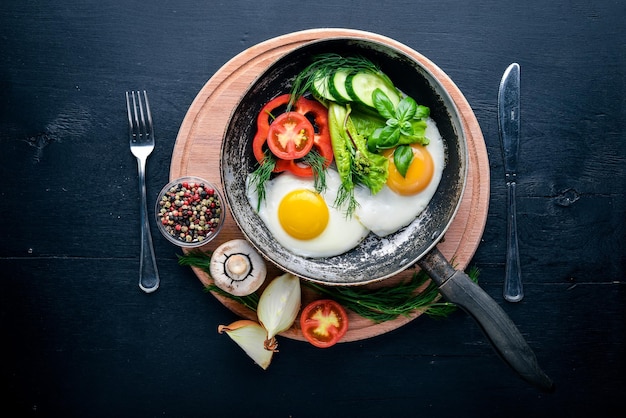 Fried egg with herbs and vegetables in a frying pan Top view Free space