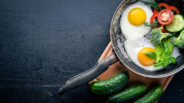 Fried egg with herbs and vegetables in a frying pan Top view Free space