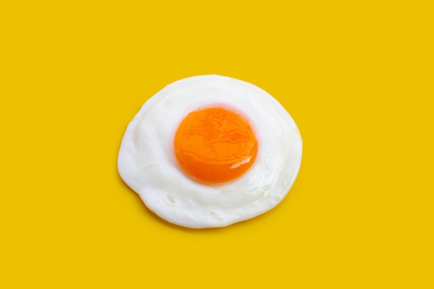 Fried egg on yellow background.