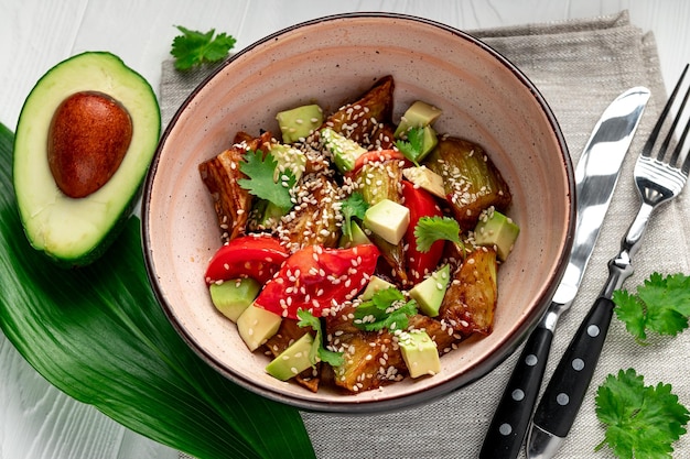 Fried eggplant with avocado tomatoes and sesame seeds Asian cuisine